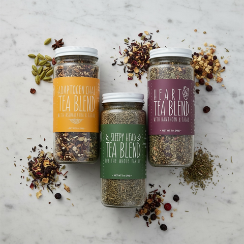 Jars of loose herbal tea on a marble background
